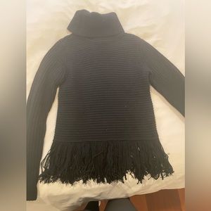 Black Michael Kors turtle neck with fringe on bottom. Size XXS